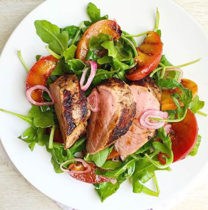 Arugula salad and grilled peaches with spiced pork tenderloin